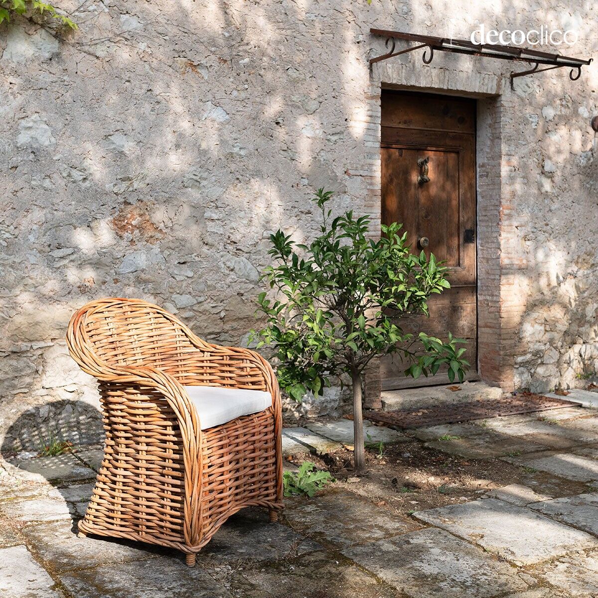 Wicker armchair with chevron canvas seat cushion